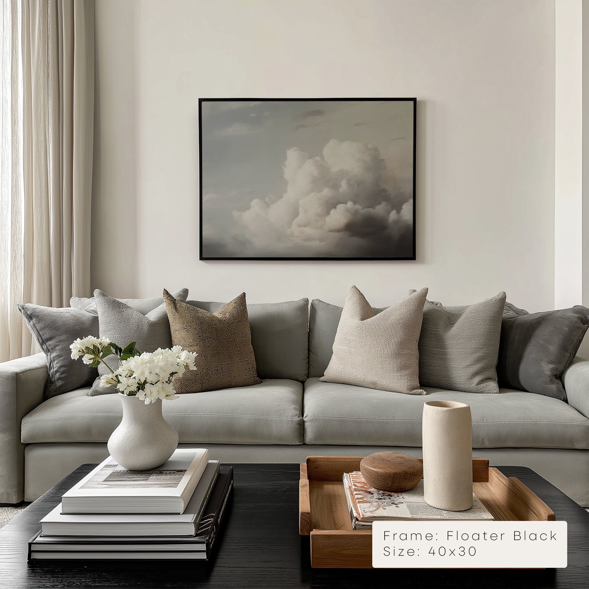 Modern living room with a gray sofa, decorative pillows, and a framed artwork on the wall.