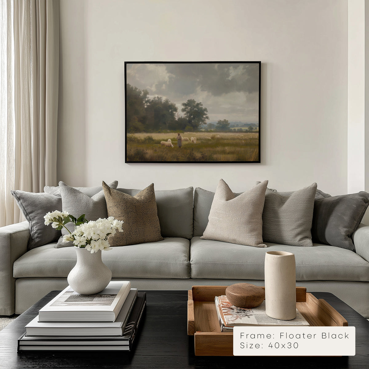 Living room with a gray sectional sofa, decorative pillows, and a framed painting on the wall.