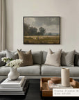 living room with a gray sectional sofa, decorative pillows, and a framed painting on the wall.