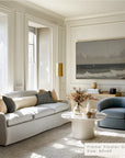 modern living room with a gray sofa, round coffee table, and wall art. __lifestyleimage