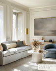 modern living room with a sofa, armchair, and wall art.