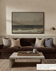 living room with a brown sofa, marble coffee table, and framed artwork on the wall.