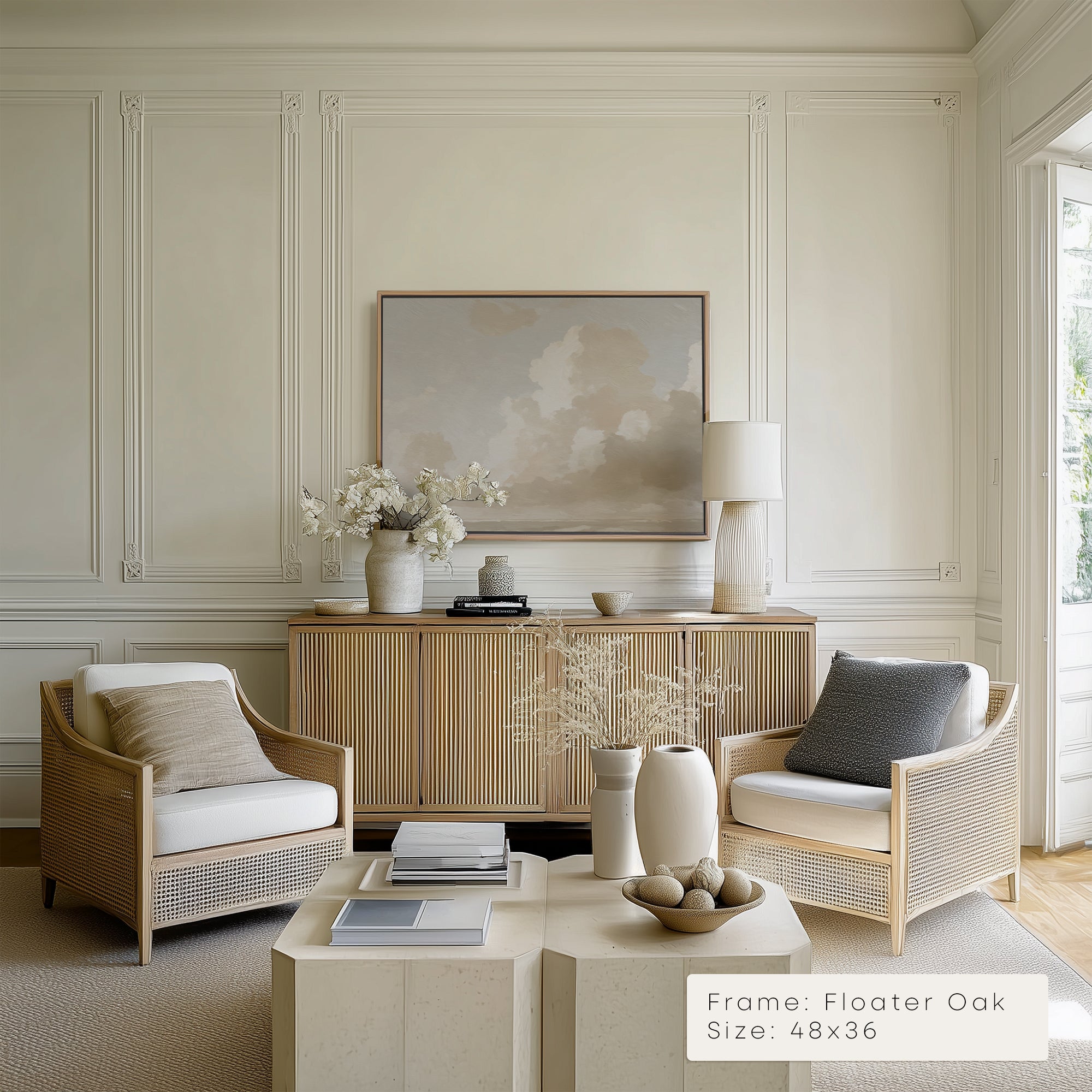 Modern living room with wicker chairs, a coffee table, and a framed artwork on the wall.