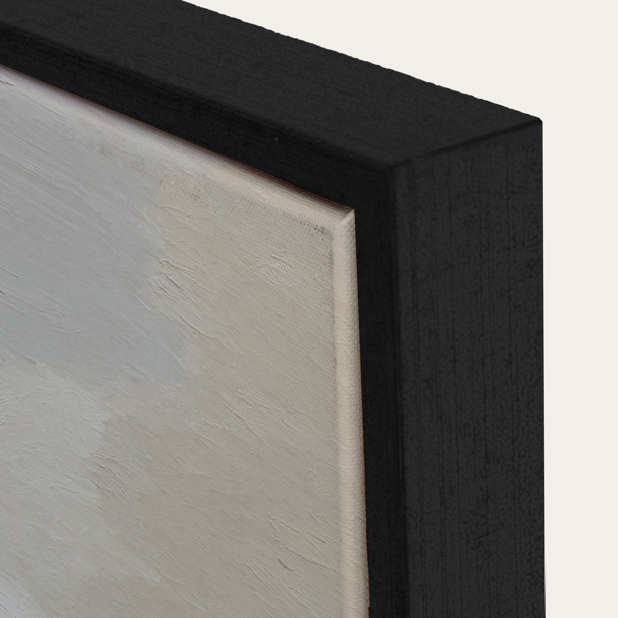 Close-up of a black frame corner with a light-colored interior. 