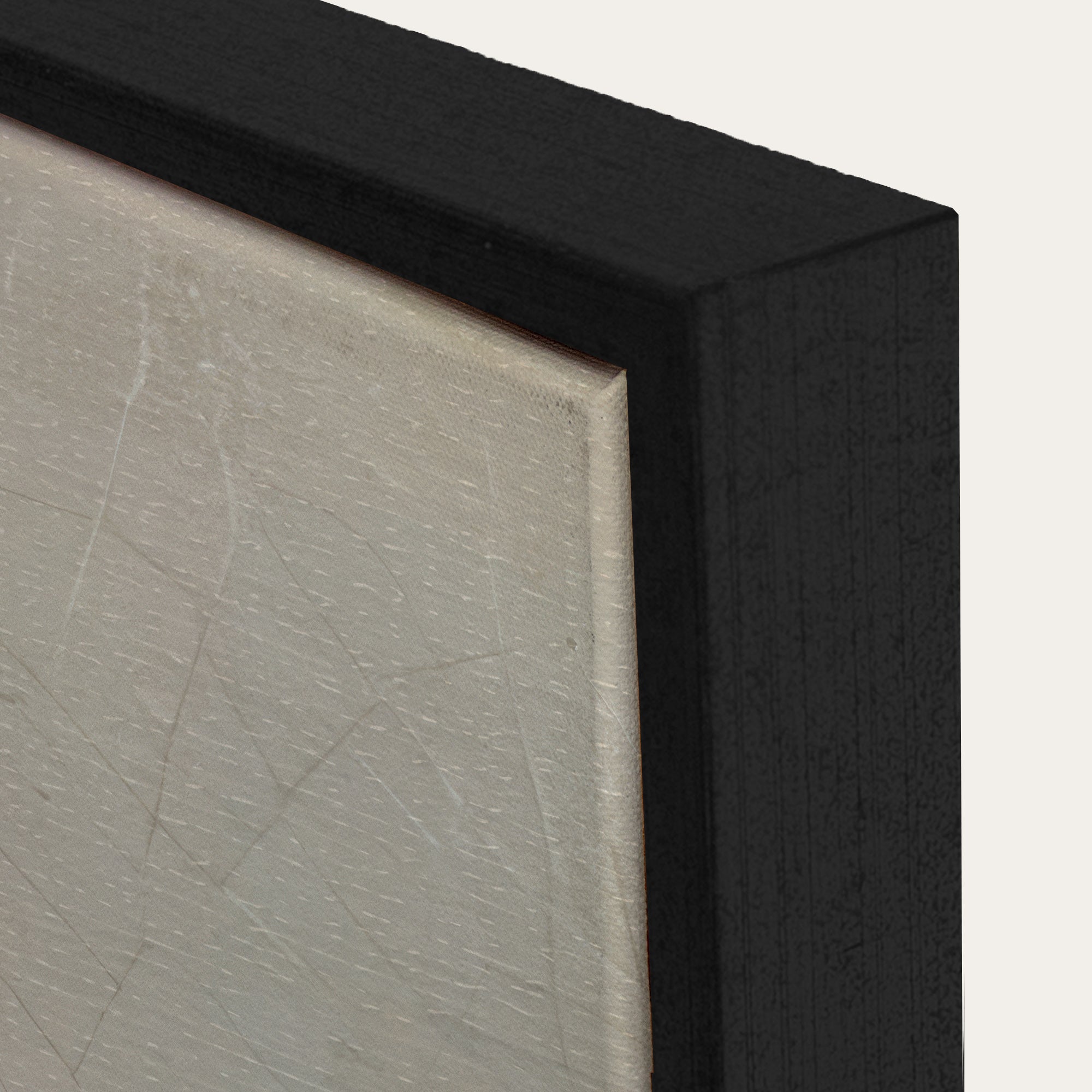 Close-up of a black frame corner with a textured gray surface. 