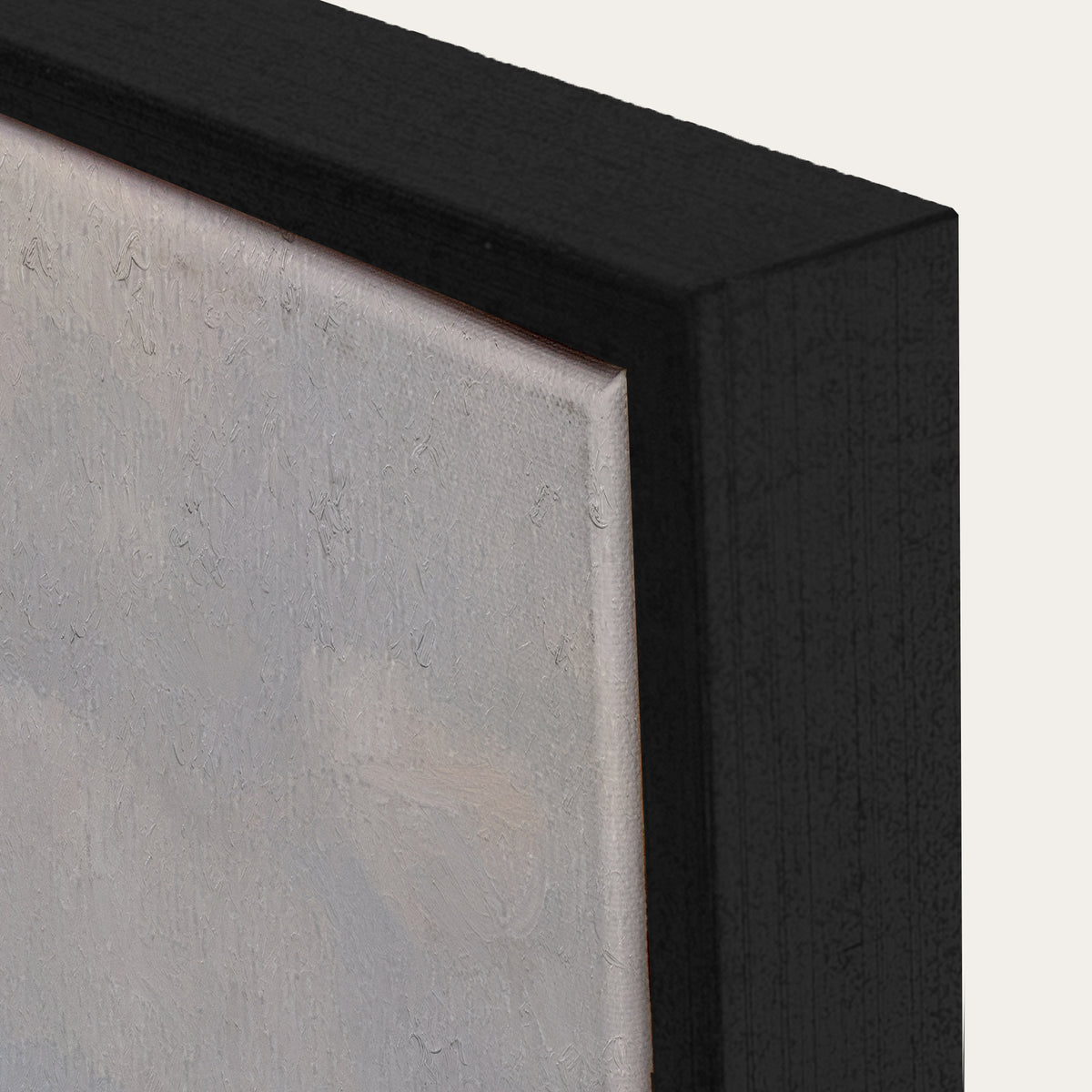Close-up of a black frame corner with a textured gray surface. 