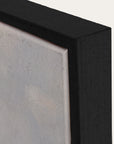 close-up of a black frame corner with a textured gray surface. 
