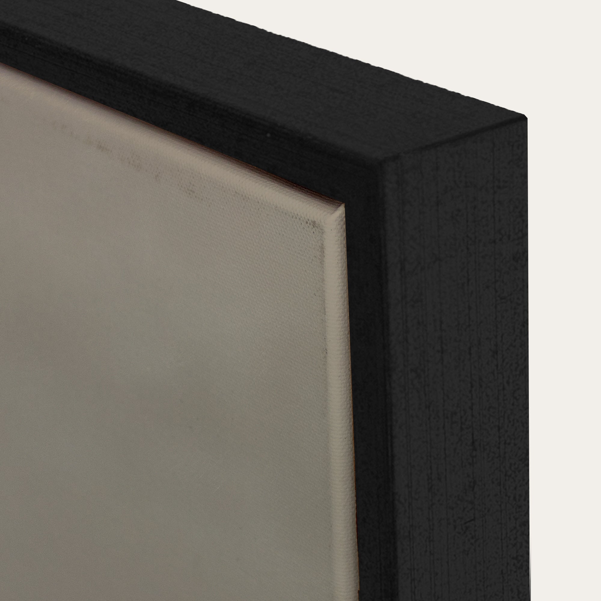 Close-up of a black rectangular object with a textured surface on a light gray background 