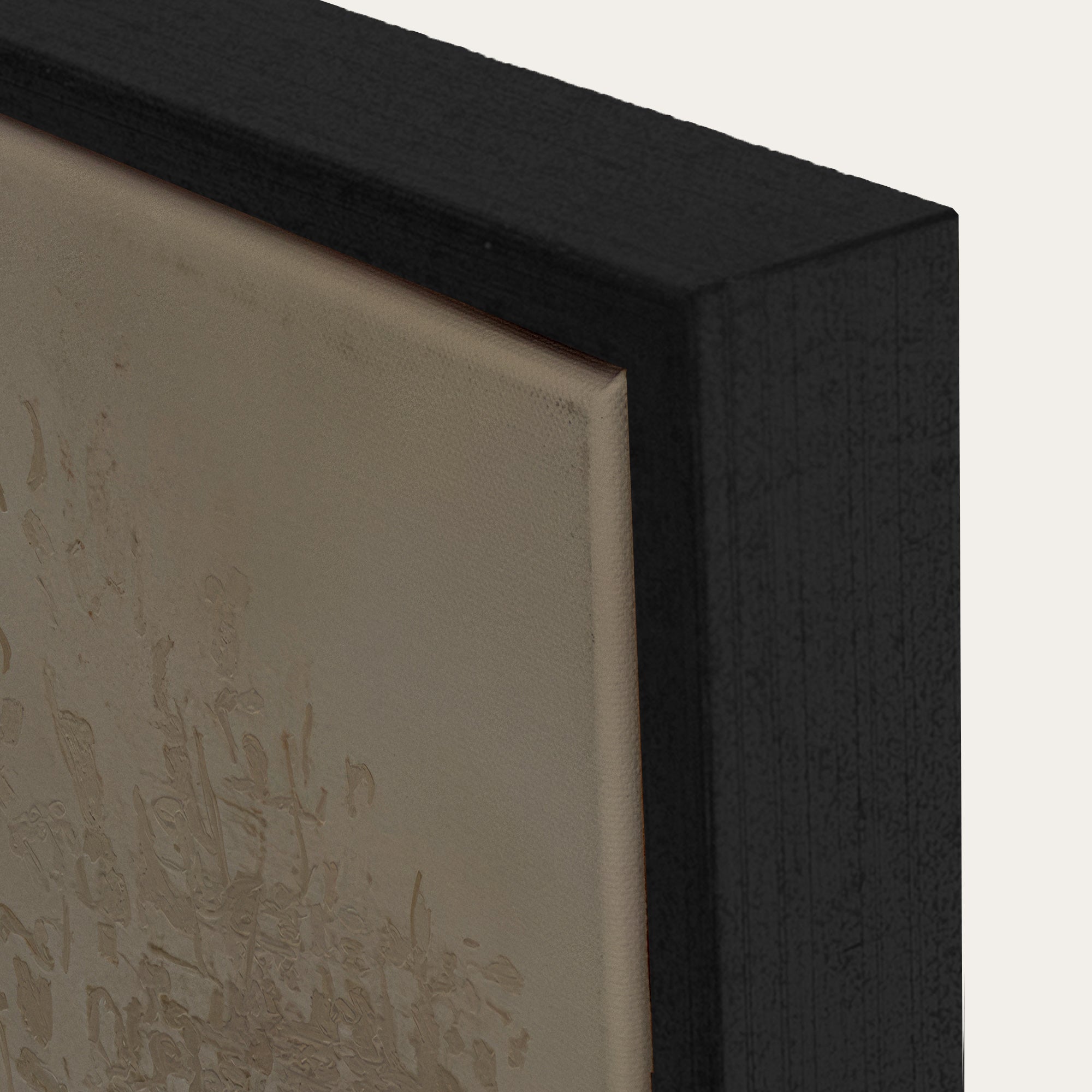 Close-up of a black framed artwork with textured beige background 