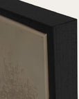 close-up of a black framed artwork with textured beige background 