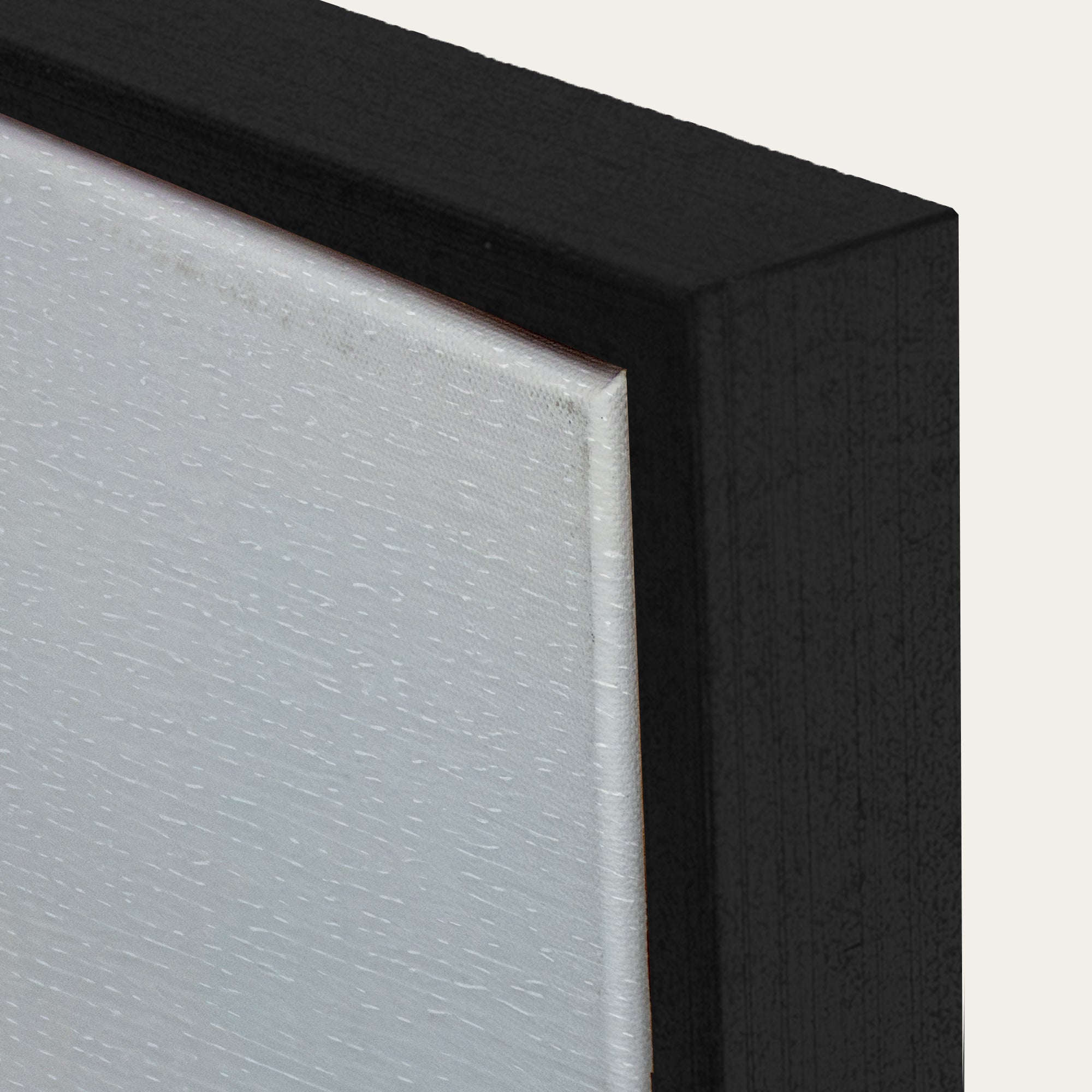Close-up of a black frame corner with a textured white surface. 