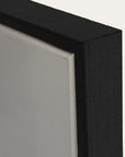 close-up of a black picture frame corner with a white background 