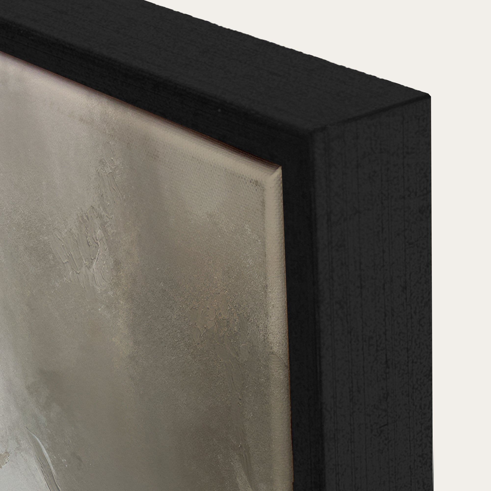 Close-up of a textured wall art piece with a black frame. 