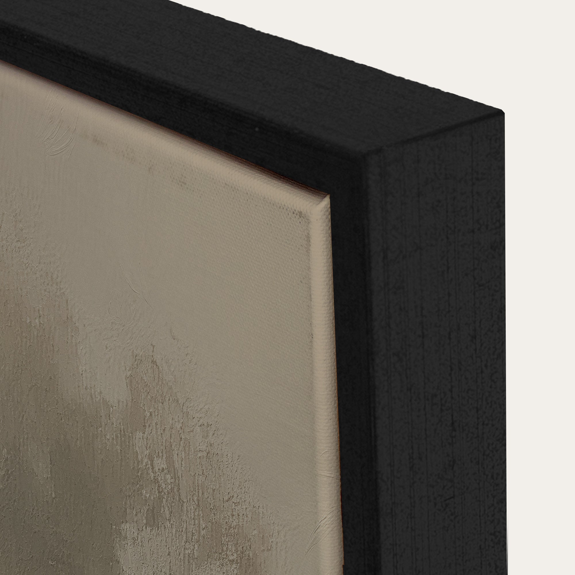 Close-up of a black frame corner with a textured beige surface. 