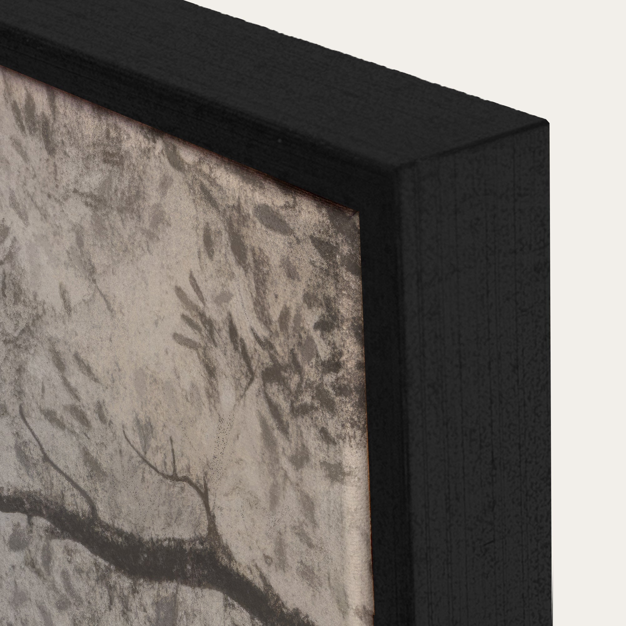 Close-up of a framed artwork with a black frame and textured gray background. 