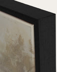 close-up of a textured wall art piece with a black frame. 