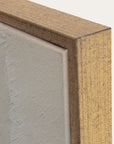 close-up of a wooden frame corner with a textured gray surface inside 