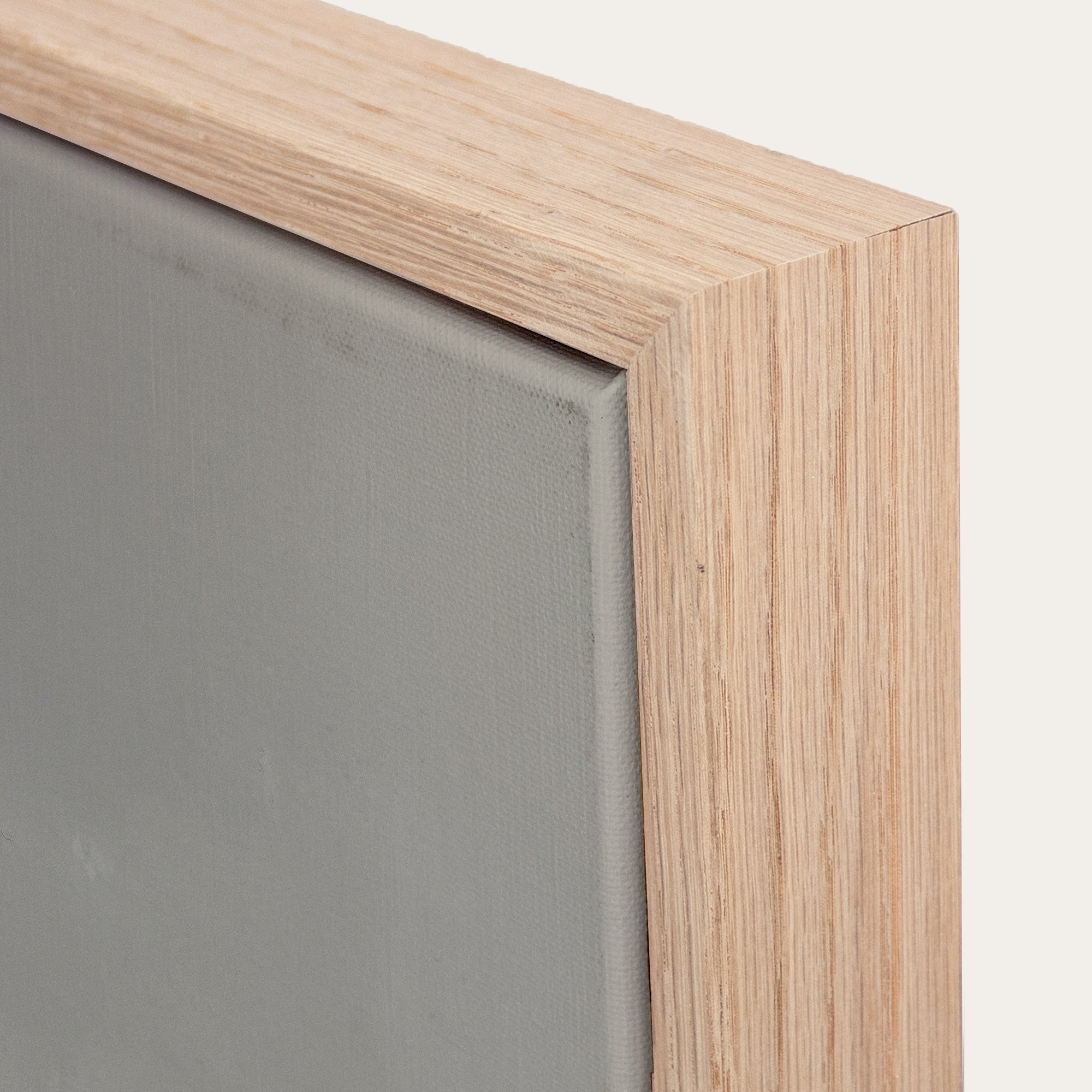 Close-up of a wooden frame corner with a gray background 