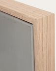 close-up of a wooden frame corner with a gray background 