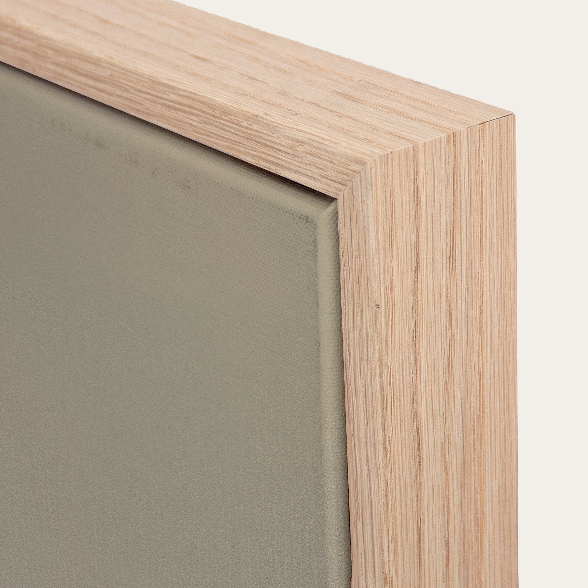Close-up of a wooden frame corner with a green background 