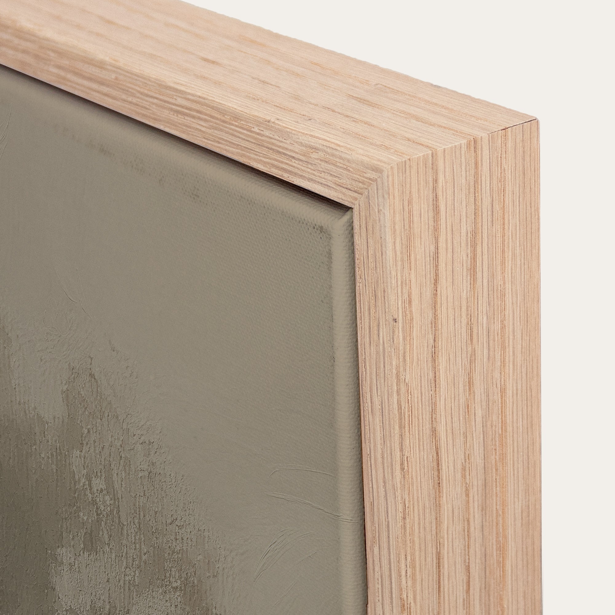 Close-up of a wooden frame corner with a textured green background 