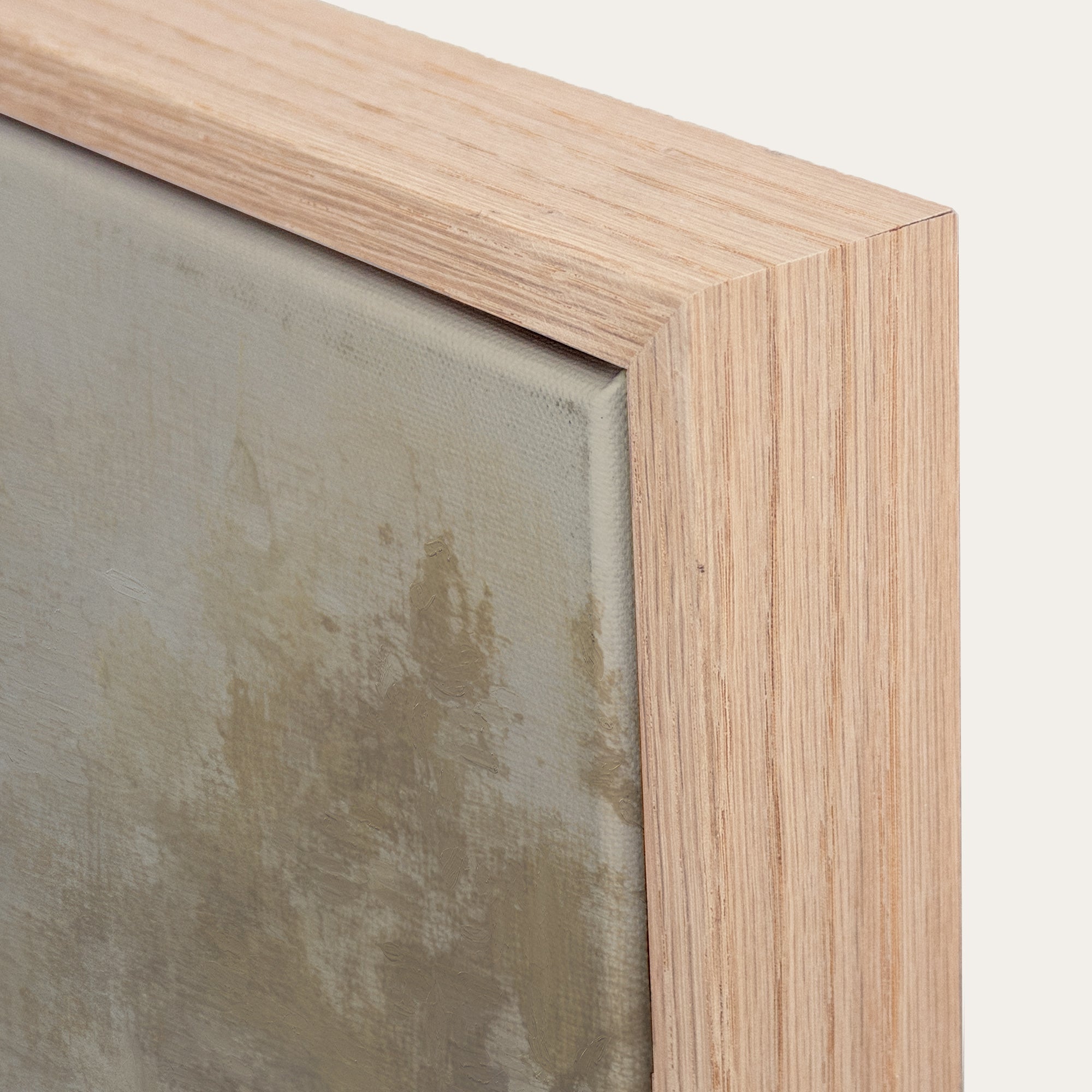 Close-up of a wooden picture frame corner with a neutral background 