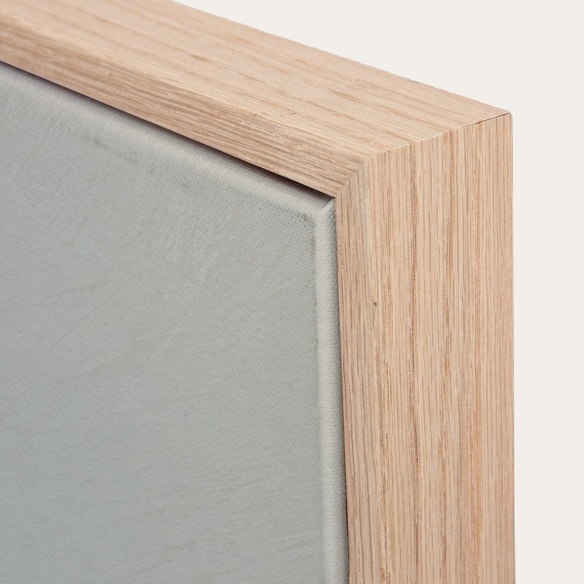 Close-up of a wooden frame corner with a gray background 