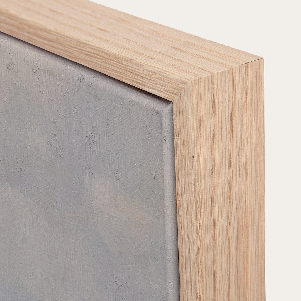 Close-up of a wooden frame with a gray textured surface inside 