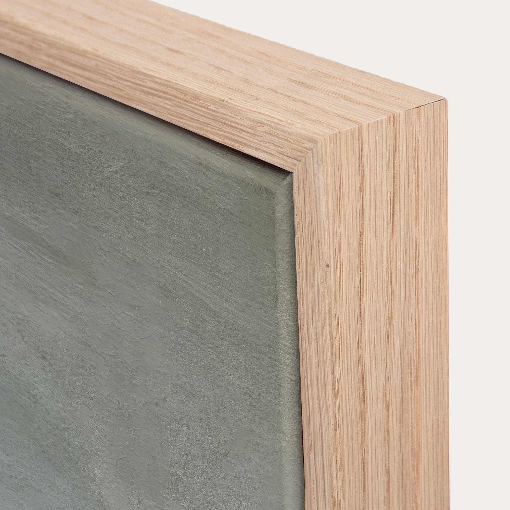 Close-up of a wooden frame corner with a gray background 