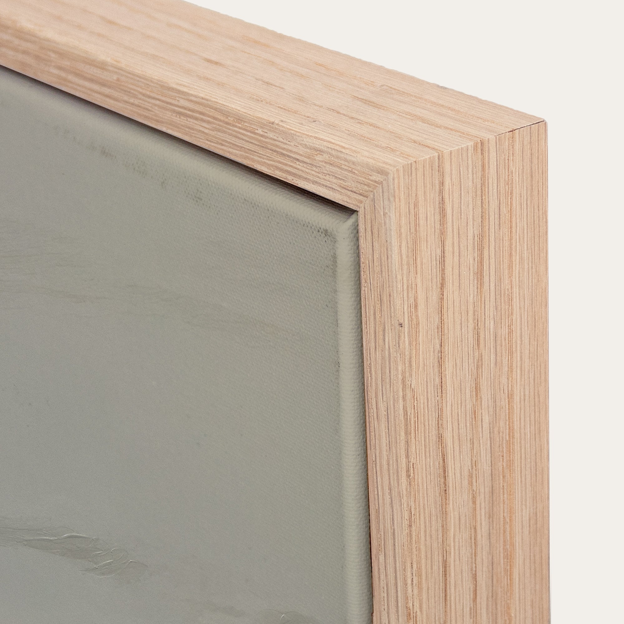 Close-up of a wooden frame corner with a neutral background 