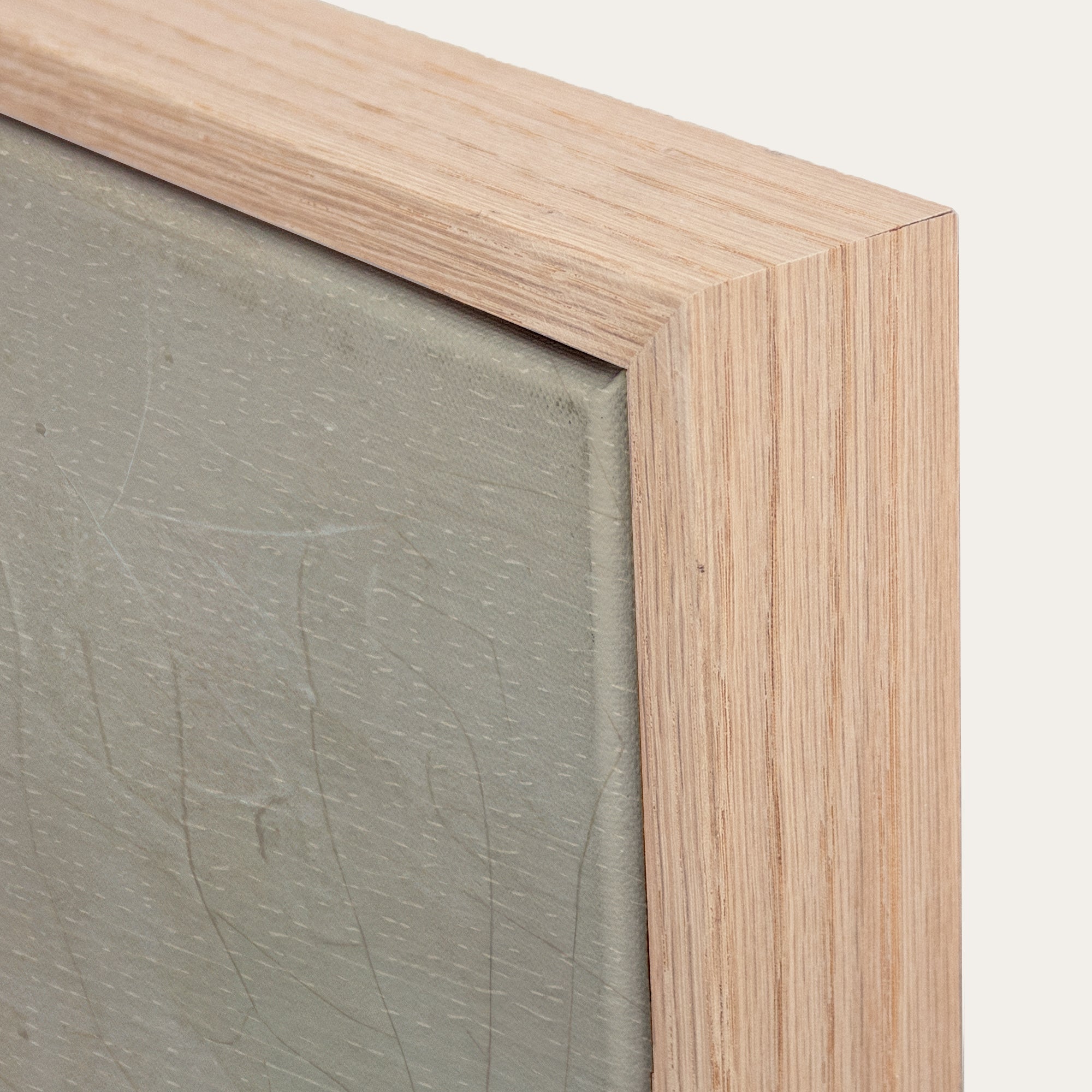 Close-up of a wooden frame with a textured green surface inside 