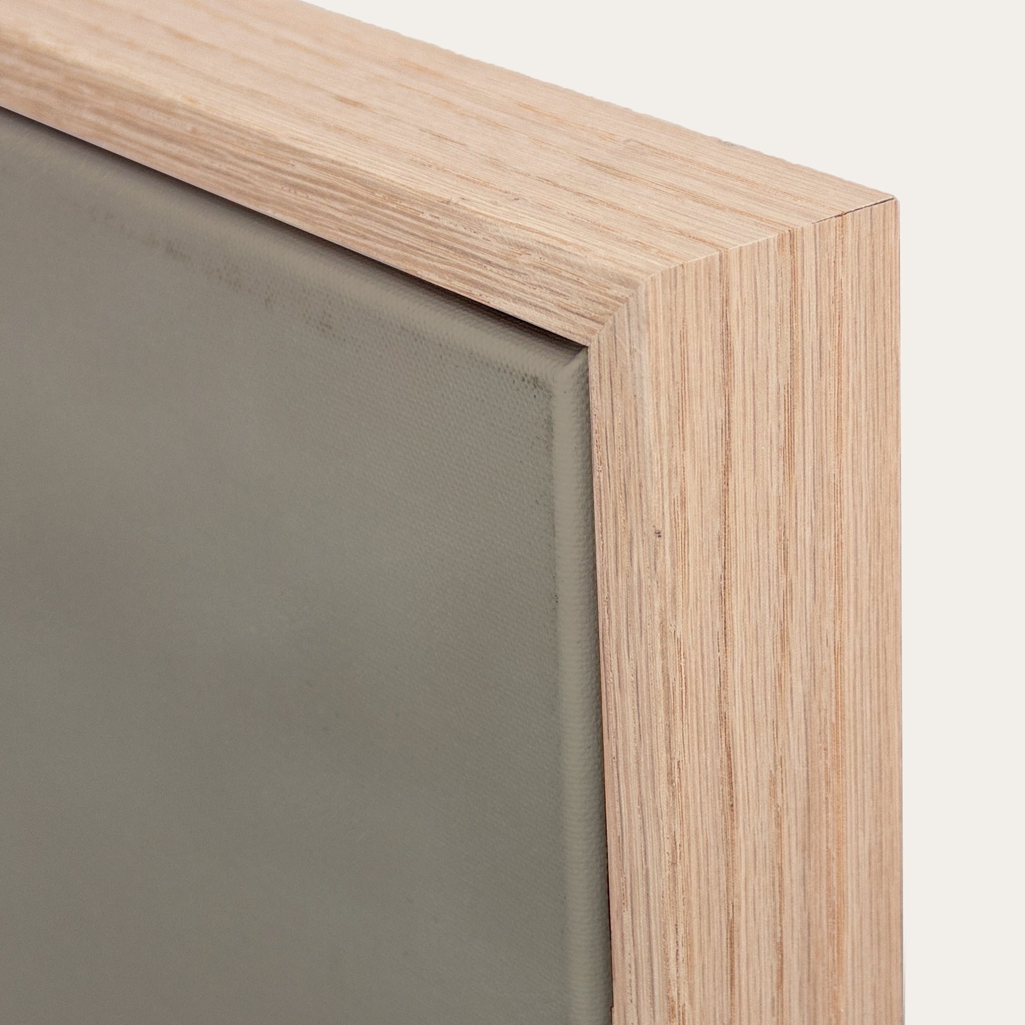 Close-up of a wooden frame corner with a gray background 