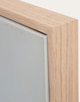 close-up of a wooden picture frame corner with a neutral background 