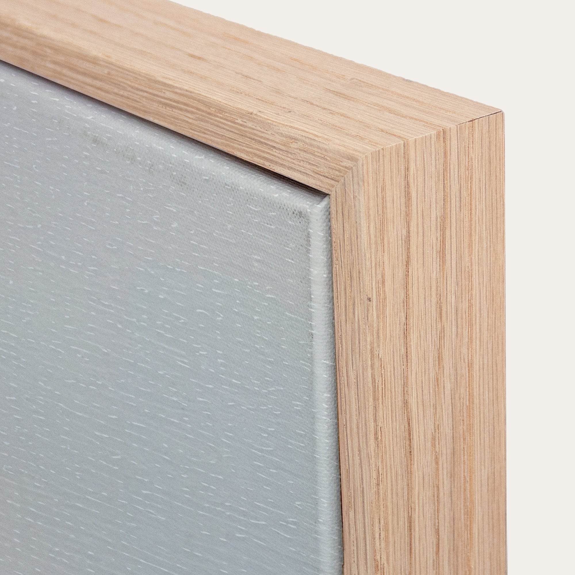 Close-up of a wooden frame corner with a textured gray surface. 