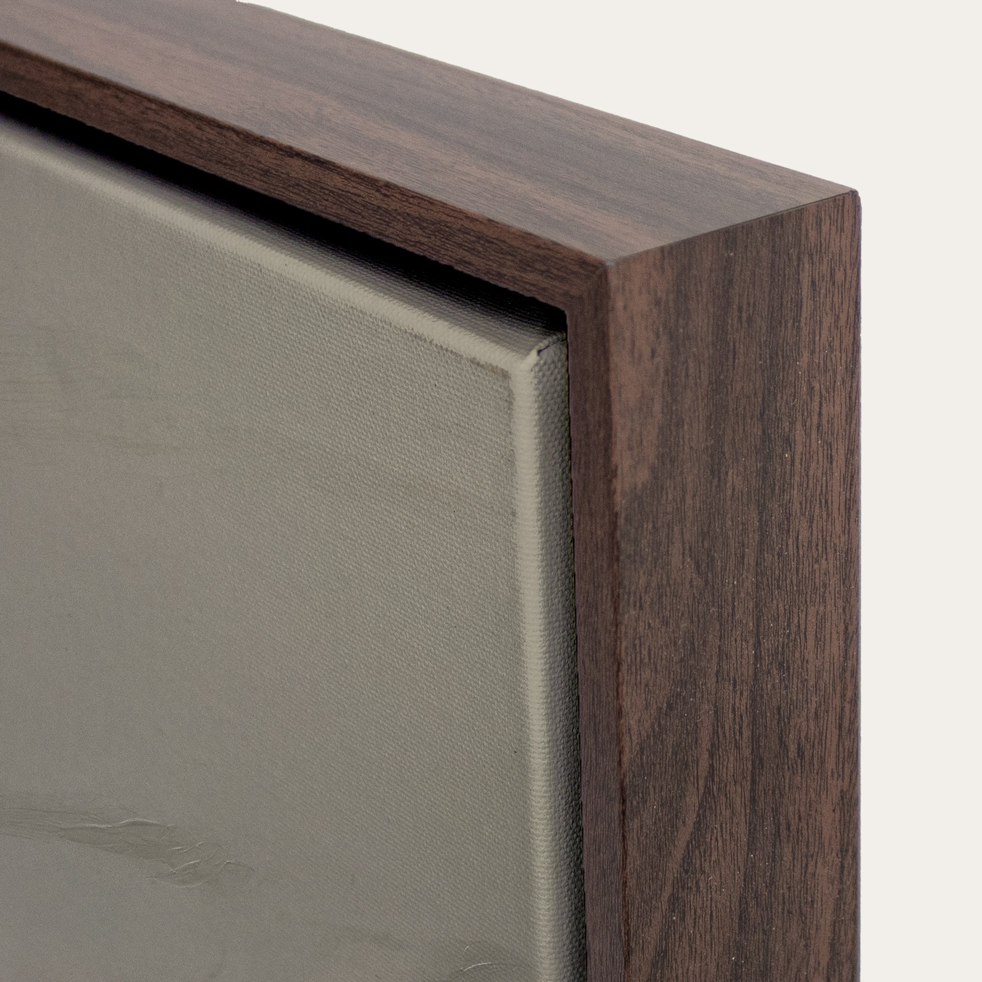 Close-up of a wooden frame corner with a neutral background 