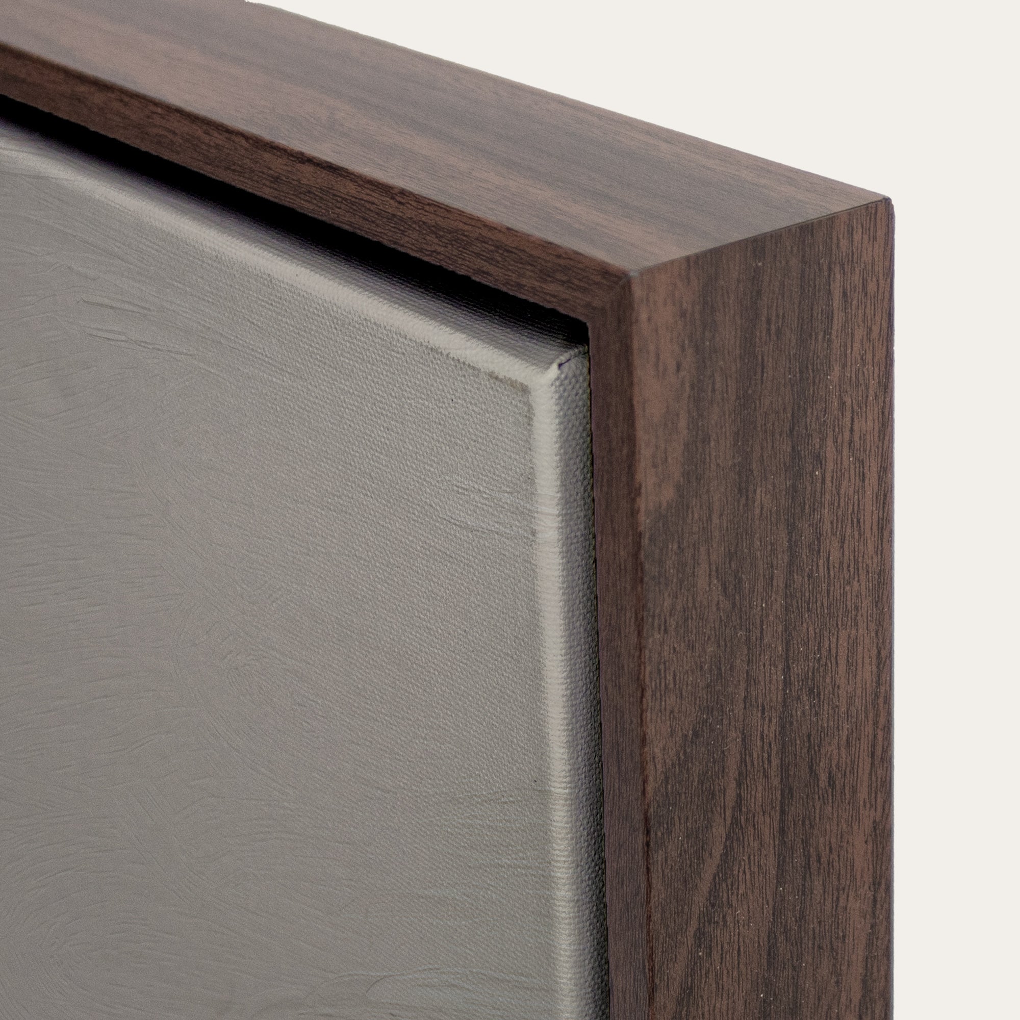 Close-up of a wooden frame corner with a neutral background 