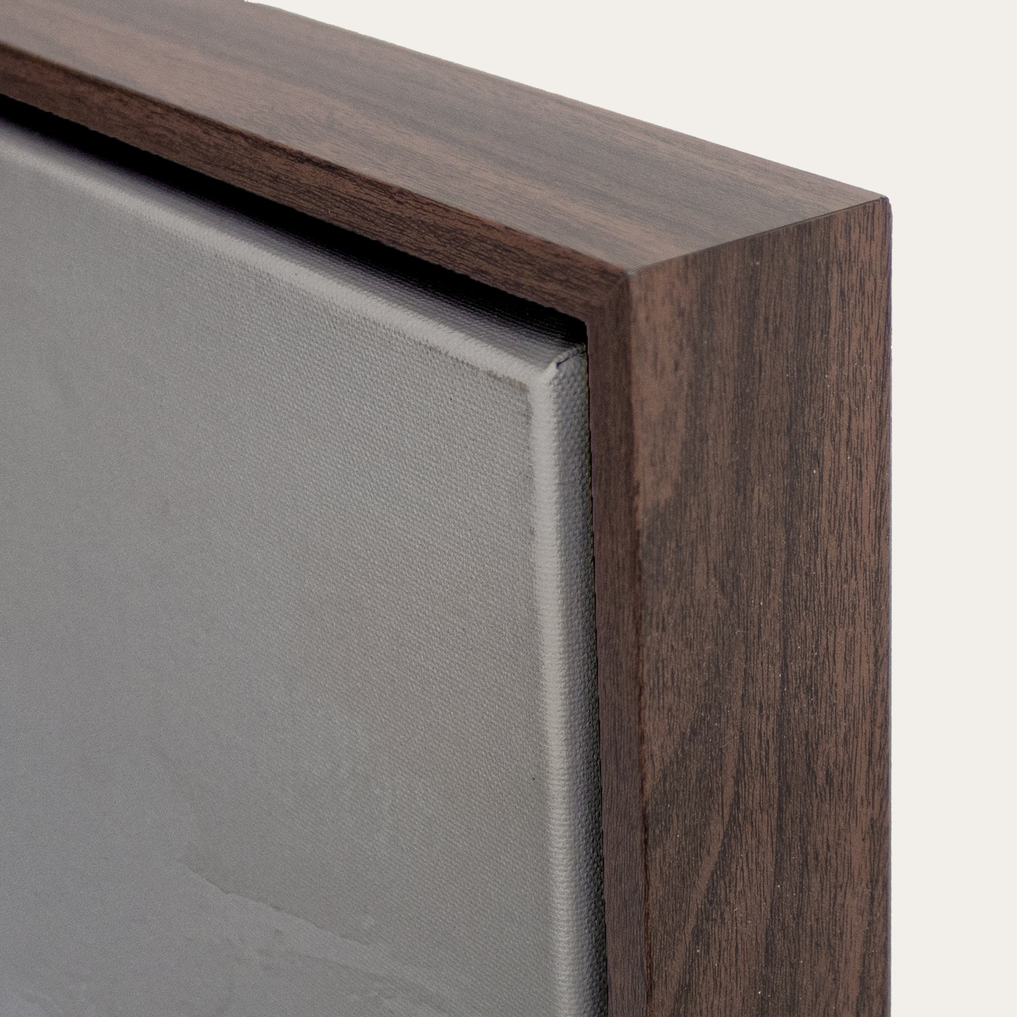Close-up of a wooden frame corner with a neutral background 