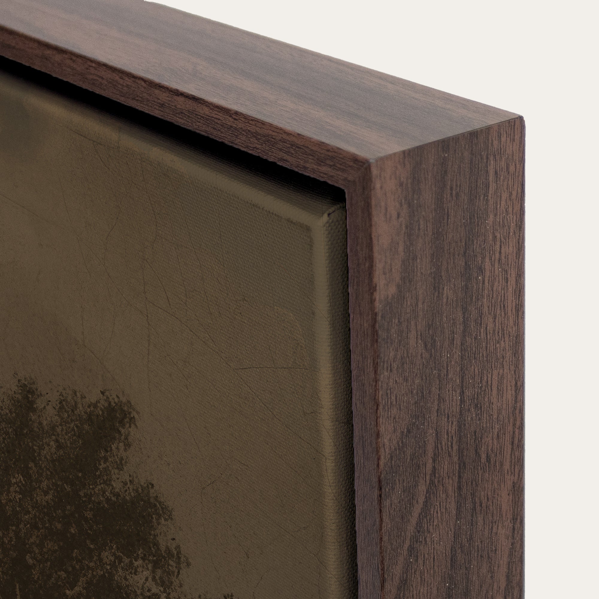 Close-up of a wooden picture frame corner with a blurred painting inside. 