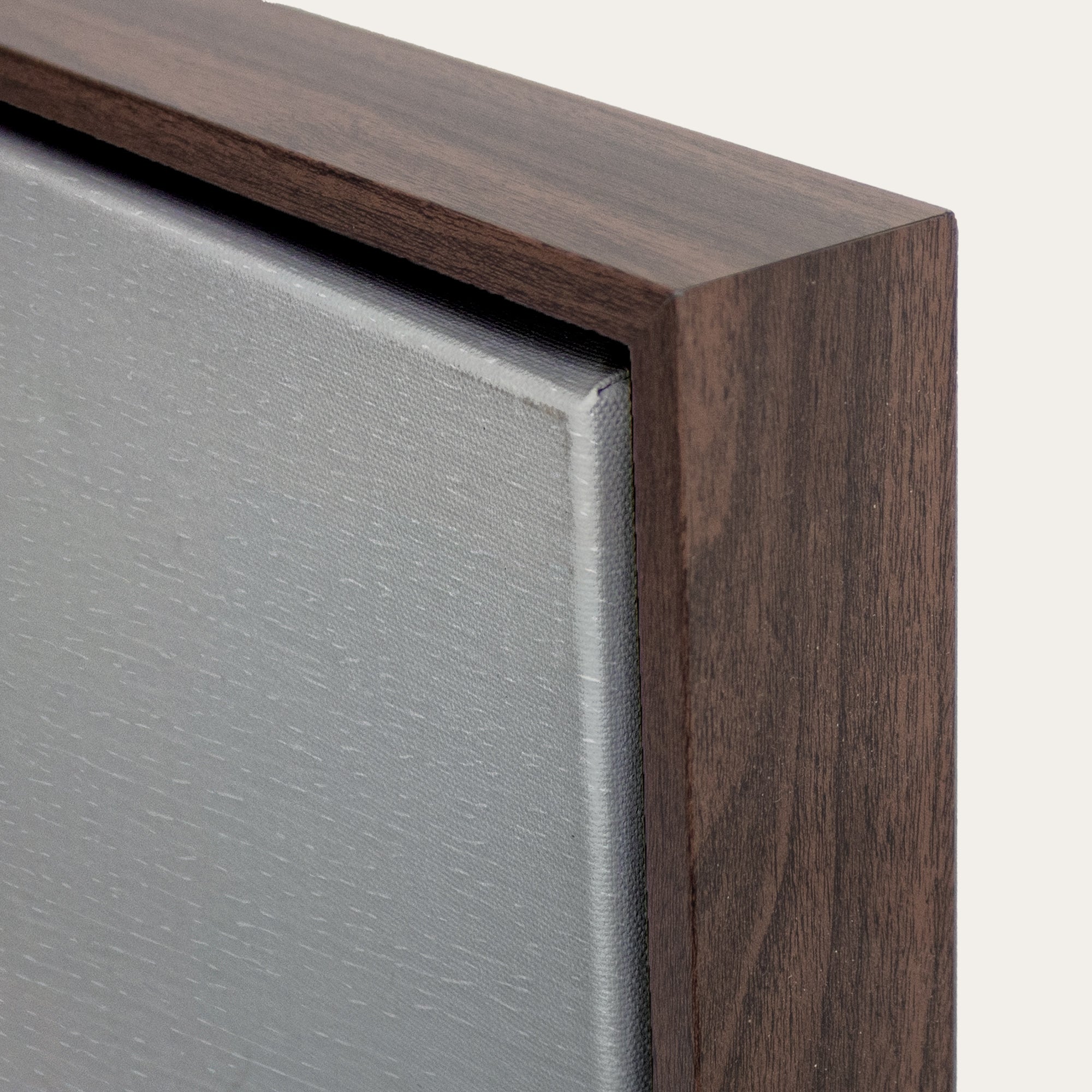 Close-up of a wooden frame corner with a neutral background 
