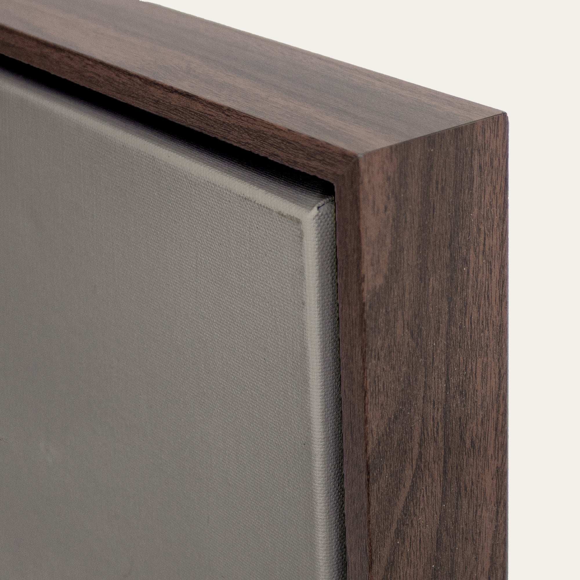 Close-up of a wooden frame corner on a gray background 