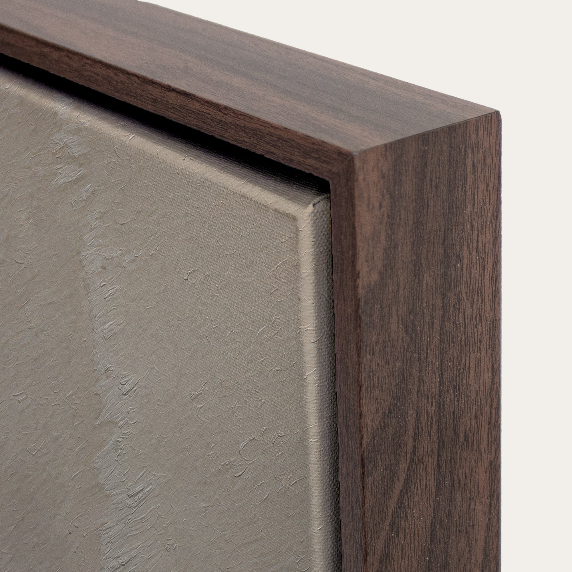 Close-up of a wooden frame corner with a neutral background 