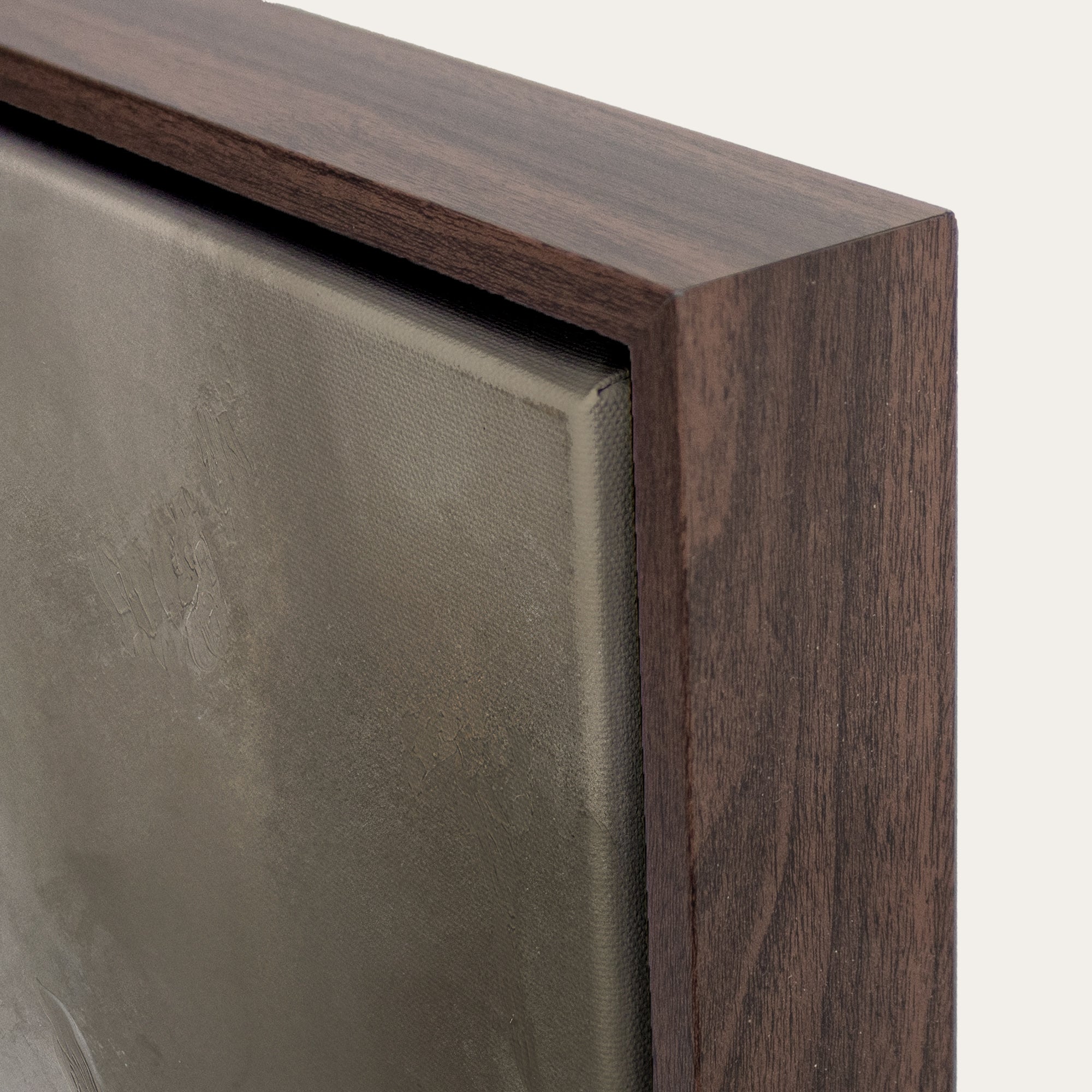 Close-up of a wooden frame corner on a gray background 