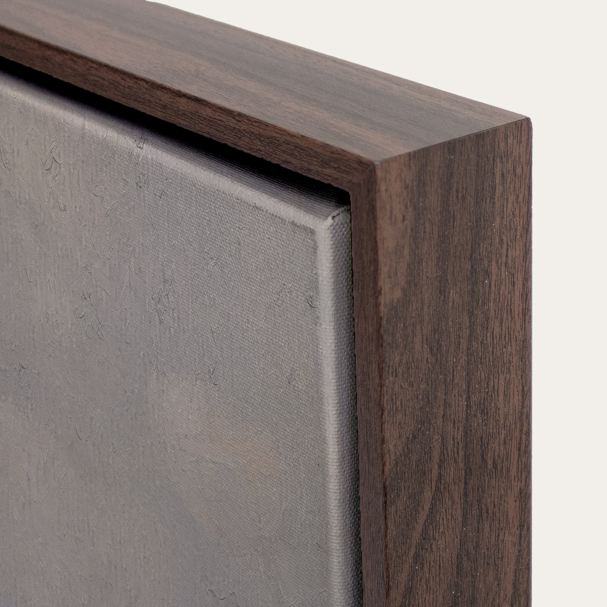 Close-up of a wooden frame corner with a gray surface 