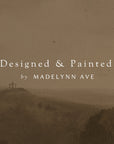 hilly landscape with crosses on a brown textured background, featuring text 'designed & painted by madelynn ave'.