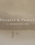 two people walking with a dog on a sandy landscape, with 'designed & painted by madelynn ave' text overlay.