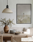 dining room with wooden table, vase with plants, and framed artwork on the wall.