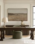 modern office interior with a wooden desk, chair, and framed landscape art on the wall.