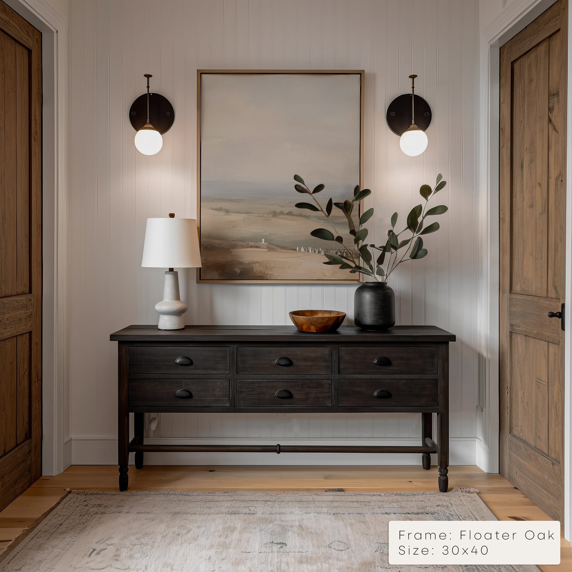 Foyer with wooden console table, lamp, and artwork on a neutral wall.