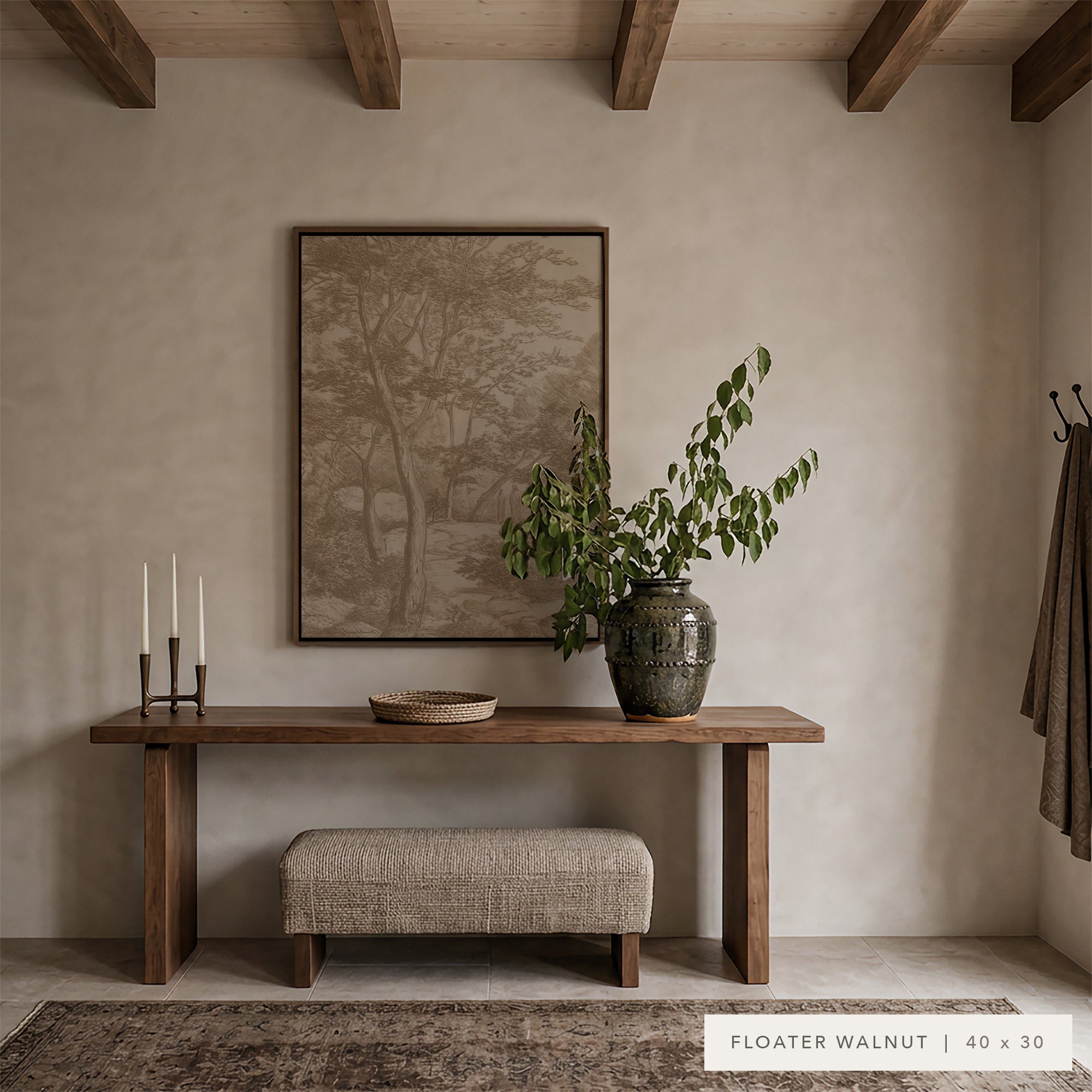 A floating walnut console table in a rustic entryway setting, styled with a matching upholstered bench, a large ceramic vase with greenery, a framed landscape print on the wall, and a rug on the floor. Text overlay at the bottom right reads 'FLOATER WALNUT | 40 x 30'.