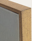 close-up of a wooden frame corner with a gray background 
